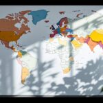 Carte du monde à colorier en ligne sur écran, avec crayons colorés posés sur un bureau moderne